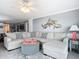 Spacious living room featuring a large sectional sofa and coastal decor at 5303 S Atlantic Ave # 270, New Smyrna Beach, FL 32169