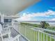 Balcony with ocean view and white chairs at 5303 S Atlantic Ave # 270, New Smyrna Beach, FL 32169