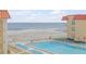 Resort-style pool with ocean view and lounge chairs at 3801 S Atlantic Ave # 307, New Smyrna Beach, FL 32169