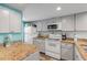 Updated kitchen with granite countertops, stainless steel appliances, and light gray cabinets at 3801 S Atlantic Ave # 307, New Smyrna Beach, FL 32169