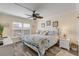 King-size bed, two nightstands, ceiling fan and lots of natural light at 3801 S Atlantic Ave # 307, New Smyrna Beach, FL 32169