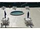 Relaxing courtyard with tables, chairs, and a small fountain at 3801 S Atlantic Ave # 307, New Smyrna Beach, FL 32169