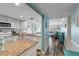 Open concept kitchen with granite countertops and white cabinets at 3801 S Atlantic Ave # 307, New Smyrna Beach, FL 32169