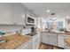 Updated kitchen with granite countertops and stainless steel appliances at 3801 S Atlantic Ave # 307, New Smyrna Beach, FL 32169