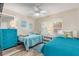 Guest bedroom with twin beds, dresser, and ceiling fan at 3801 S Atlantic Ave # 307, New Smyrna Beach, FL 32169