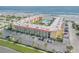 Aerial view showing a condo building, pool, parking lot and beach access at 3801 S Atlantic Ave # 307, New Smyrna Beach, FL 32169