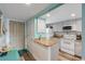 Kitchen with granite countertop and white cabinets at 3801 S Atlantic Ave # 307, New Smyrna Beach, FL 32169