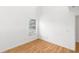Simple bedroom with large window and wood floors at 172 Gull S Dr, Daytona Beach, FL 32119