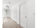 Bright hallway with tile flooring and multiple doors leading to bedrooms and closets at 172 Gull S Dr, Daytona Beach, FL 32119
