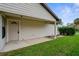 Backyard patio with a tan house exterior and green lawn at 172 Gull S Dr, Daytona Beach, FL 32119