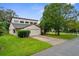 Tan two-story house with a two-car garage and mature landscaping at 172 Gull S Dr, Daytona Beach, FL 32119