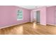 Pink bedroom with mirrored closet and window at 172 Gull S Dr, Daytona Beach, FL 32119