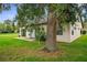 Tan house with a two-car garage and lush green lawn at 172 Gull S Dr, Daytona Beach, FL 32119
