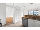 Kitchen boasts white cabinets, a dishwasher, and views into the living area at 172 Gull S Dr, Daytona Beach, FL 32119