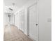Bright hallway with tile flooring and multiple doors leading to bedrooms and closets at 172 Gull S Dr, Daytona Beach, FL 32119