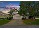 Tan two-story house with a two-car garage and mature landscaping at 172 Gull S Dr, Daytona Beach, FL 32119
