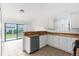 Kitchen features ample counter space, white cabinets, and a view of the backyard at 172 Gull S Dr, Daytona Beach, FL 32119