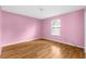 Pink bedroom with wood-look floors at 172 Gull S Dr, Daytona Beach, FL 32119