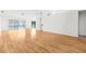 Open living room with laminate flooring and access to backyard at 172 Gull S Dr, Daytona Beach, FL 32119