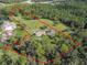 Aerial view of property highlighting house, pond, and wooded area at 2471 Jenscot Rd, Saint Cloud, FL 34771