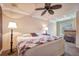 King-size bed in well-lit bedroom with ceiling fan at 3608 Romea Cir, New Smyrna Beach, FL 32168