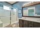 Double vanity bathroom with a walk in shower, and updated fixtures at 3608 Romea Cir, New Smyrna Beach, FL 32168