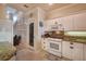 Bright kitchen with white cabinets, granite countertops, and stainless steel appliances at 3608 Romea Cir, New Smyrna Beach, FL 32168