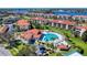 Aerial view of community pool, clubhouse, and waterfront property at 452 Bouchelle Dr # 303, New Smyrna Beach, FL 32169