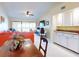 Spacious living room with red sectional sofa and access to a balcony overlooking the water at 452 Bouchelle Dr # 303, New Smyrna Beach, FL 32169