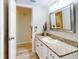 Bathroom with granite countertop, white cabinets, and wood-look flooring at 452 Bouchelle Dr # 303, New Smyrna Beach, FL 32169