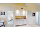 White wet bar with granite countertop and ample cabinet storage at 452 Bouchelle Dr # 303, New Smyrna Beach, FL 32169