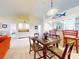 Bright dining area with a wooden table and chairs, view into kitchen and living room at 452 Bouchelle Dr # 303, New Smyrna Beach, FL 32169