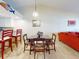 Dining area with table and chairs, and kitchen view at 452 Bouchelle Dr # 303, New Smyrna Beach, FL 32169