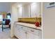 Built-in wet bar with granite countertop and white cabinets at 452 Bouchelle Dr # 303, New Smyrna Beach, FL 32169