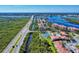 Aerial view of community, tennis courts and waterway at 452 Bouchelle Dr # 303, New Smyrna Beach, FL 32169