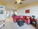 Spacious living area with red sofa and views into dining and kitchen areas at 452 Bouchelle Dr # 303, New Smyrna Beach, FL 32169