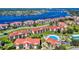 Aerial view of waterfront community with pool and lush landscaping at 452 Bouchelle Dr # 303, New Smyrna Beach, FL 32169