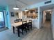 Kitchen with breakfast bar, dining table for four, and light wood cabinets at 5207 S Atlantic Ave # 0622, New Smyrna Beach, FL 32169