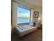 Relaxing chaise lounge with stunning ocean view from large window at 5207 S Atlantic Ave # 0622, New Smyrna Beach, FL 32169