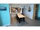 Bright dining area with table and chairs, and kitchen in the background at 5207 S Atlantic Ave # 0622, New Smyrna Beach, FL 32169