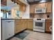 Modern kitchen featuring white appliances and wood cabinets at 5207 S Atlantic Ave # 0622, New Smyrna Beach, FL 32169