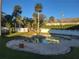 Inviting kidney-shaped pool with surrounding brick patio and lush landscaping at 1012 S Riverside Dr, Edgewater, FL 32132