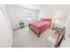 Cozy bedroom with a wooden bed frame, carpet flooring, and neutral decor at 110 Ponce Terrace Cir, Ponce Inlet, FL 32127