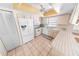 Bright kitchen features white appliances and tile flooring at 110 Ponce Terrace Cir, Ponce Inlet, FL 32127