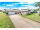 Two-story home with attached garage and manicured lawn at 110 Ponce Terrace Cir, Ponce Inlet, FL 32127