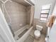 Bathroom with tub, shower, toilet and window at 110 Ponce Terrace Cir, Ponce Inlet, FL 32127