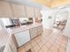 Kitchen with tile countertops and ample cabinet storage at 110 Ponce Terrace Cir, Ponce Inlet, FL 32127