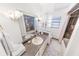 Clean bathroom with updated vanity, tiled shower, and glass block window at 110 Ponce Terrace Cir, Ponce Inlet, FL 32127