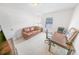 Bright home office features a leather sofa, wood desk, and ample natural light at 110 Ponce Terrace Cir, Ponce Inlet, FL 32127