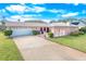 Single-story home with attached garage and landscaping at 110 Ponce Terrace Cir, Ponce Inlet, FL 32127